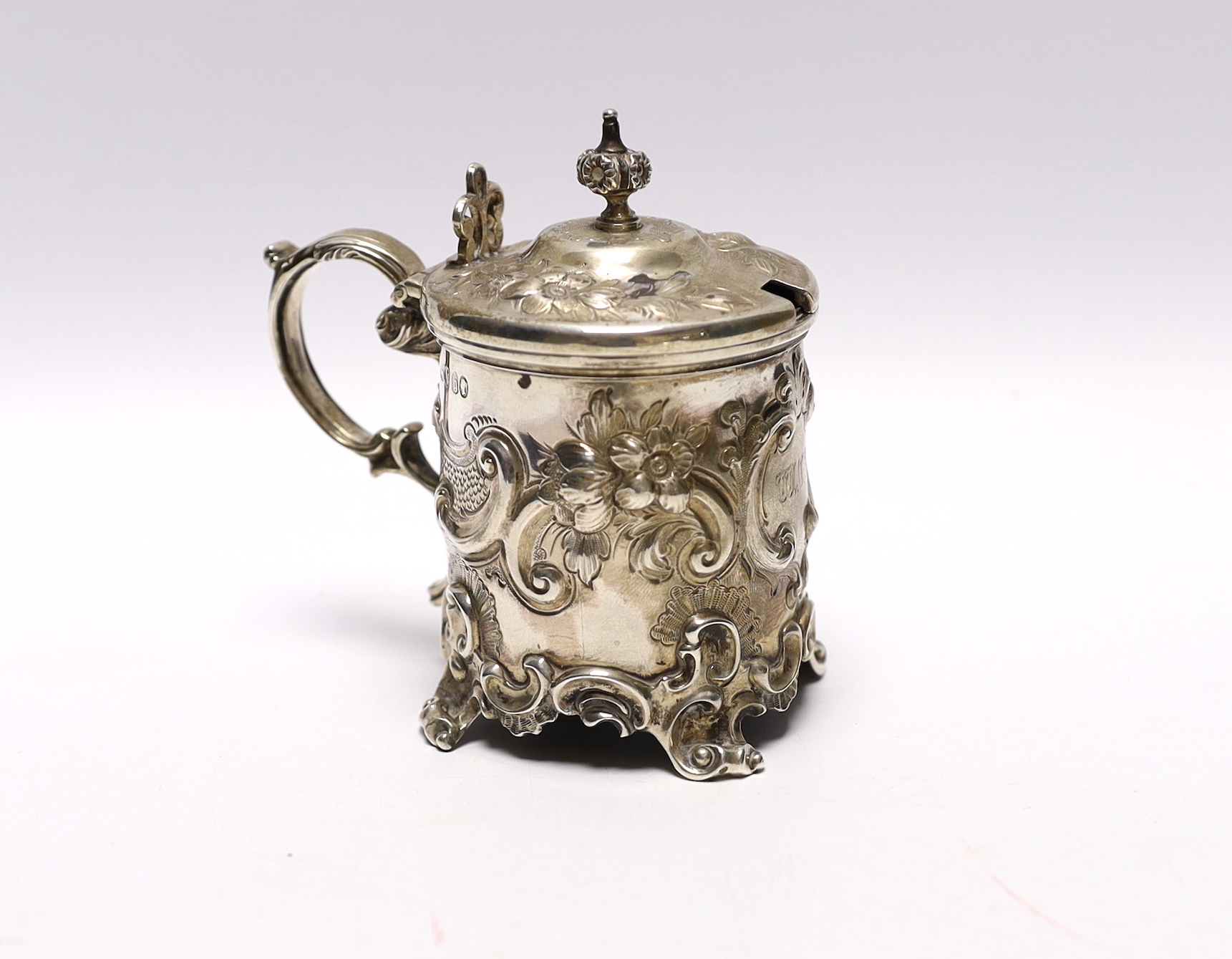 A Victorian embossed silver drum mustard, John Evans II, London, 1863, decorated with foliage and scrolls.
